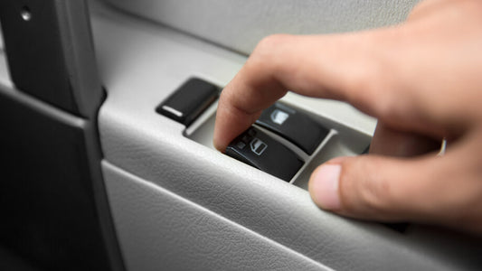 finger on button to roll up car window